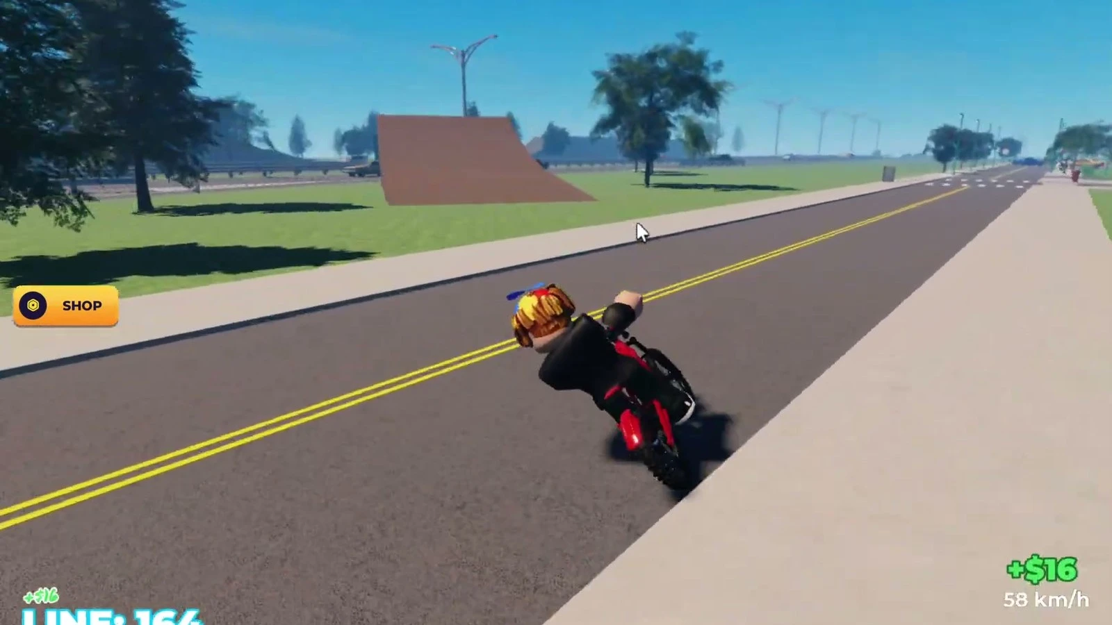 A rider on a marked Bike Universe road with ramps and wind turbines along the highway